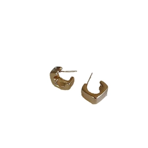 Minimalist golden C-shape geometric hoop earrings with polished metallic finish