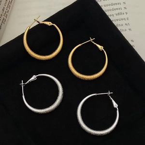 Matte gold and silver geometric large hoop earrings with frosted textured finish