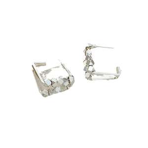 Minimalist silver arc geometric earrings with textured metallic granules and industrial style
