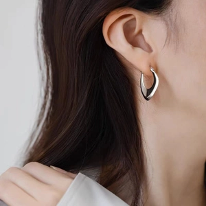 Minimalist silver geometric V-shaped hoop earrings for women with a sleek sculpted design
