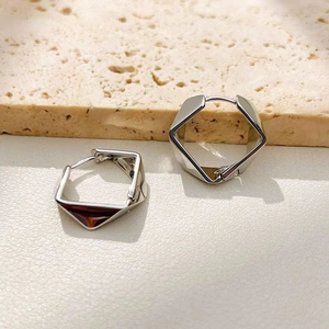 Minimalist silver geometric rhomboid hoop earrings in a polished metallic finish