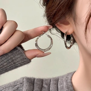 Minimalist silver double-layered round hoop earrings with delicate textured grooved bands