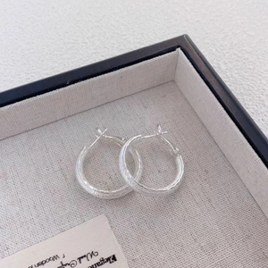 Minimalist silver matte hoop earrings for women with frosted texture on linen jewelry tray