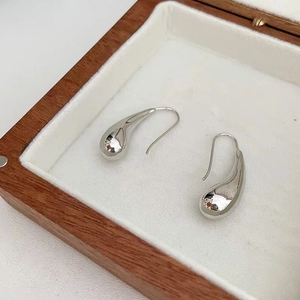 Polished 18K gold plated hollow teardrop earrings displayed on a luxury jewelry box