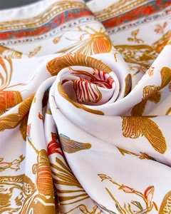Macro detail of French butterfly floral print on soft silk-like square scarf fabric