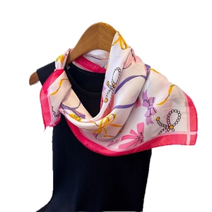Silk-like white square scarf with pink ribbon print and golden chain details