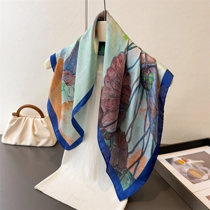 Artistic lotus print faux silk scarf with impressionist pattern on white mannequin