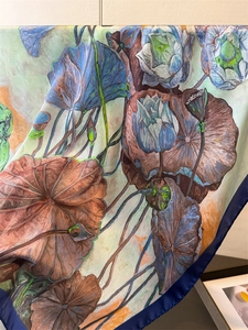 Detailed drape of lotus print silk scarf showing smooth texture and oil painting pattern
