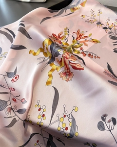 Detailed view of pink satin silk scarf with vintage lily floral and berry botanical prints
