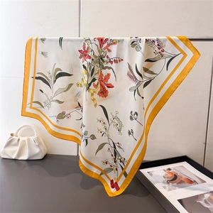 Floral printed silk-like square scarf featuring elegant yellow and orange botanical patterns