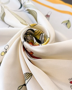Detailed view of floral satin square scarf showing smooth silk texture and botanical prints