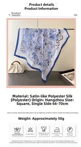 Close-up of blue and white floral pattern satin silk scarf with elegant drape and luster