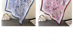 Detail of elegant satin square scarves with floral prints in navy blue and red colors