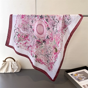 Detailed view of floral silk scarf with hand-painted nature pattern and soft drape