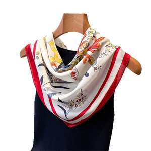 Floral print faux silk square scarf with red border displayed on a wooden hanger