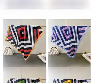 Detail view of red and purple geometric striped silk scarves with premium satin texture
