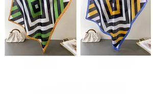 Detail view of striped silk-like scarves in green and blue colorways on a table