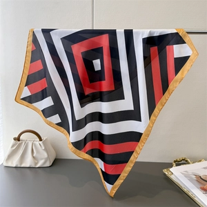 Detail showing red, black and white geometric pattern on faux silk square scarf
