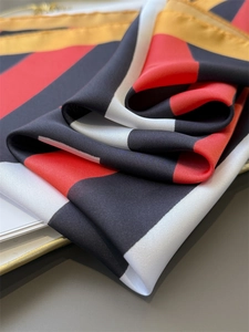 Detailed view of the smooth satin texture and colorful striped pattern on the scarf