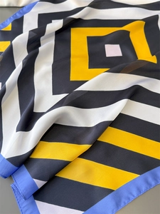 Detailed view of striped geometric silk-like scarf with vibrant color block design