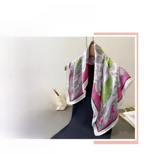 Dettaglio di un foulard in seta con motivi floreali appeso a una gruccia elegante