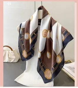 Detail of silk-like scarf with checkerboard pattern and golden lion emblem on hanger