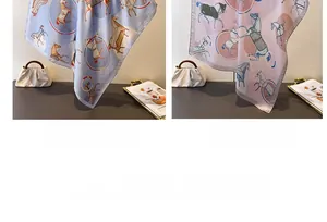 Close-up of elegant horse print scarves in dusty blue and light pink silk satin texture