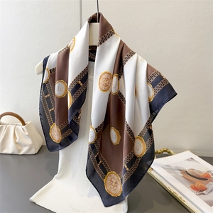 Checkerboard silk square scarf with vintage lion and chain print draped on a mannequin