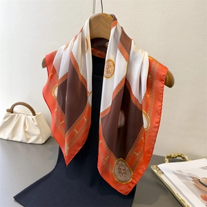 Checkerboard silk-feel square scarf with lion head and pearl print on a wooden hanger