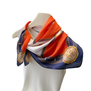 Silk-textured square scarf featuring orange and navy checkerboard with gold lion patterns
