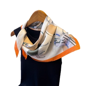 Elegant silk-like scarf with equestrian horse print and vibrant orange border on hanger
