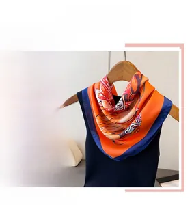 Detailed view of equestrian horse print satin scarf with orange and navy blue silk borders
