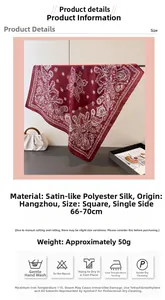Close-up of burgundy silk satin scarf with white paisley patterns and rolled edges