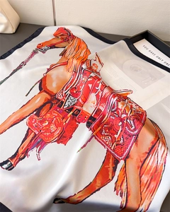 Detailed view of luxury equestrian silk scarf featuring colorful horse and saddle print