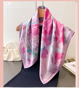 Detail of floral silk-feel scarf with vibrant pink and purple abstract ink print texture