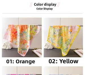 Detail view of orange and yellow floral faux silk scarves with elegant rolled edges