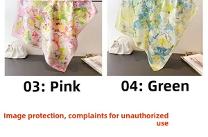 Detail of floral printed silk-like scarves in pink and green colors on a white bag