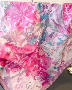 Macro detail of abstract floral printed silk scarf with smooth satin texture and vibrant colors