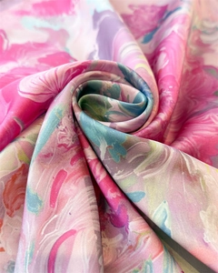 Detailed macro view of colorful abstract floral print on smooth faux silk fabric