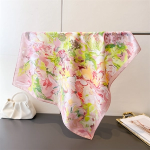 Close-up of lightweight silk square scarf with colorful abstract floral print pattern