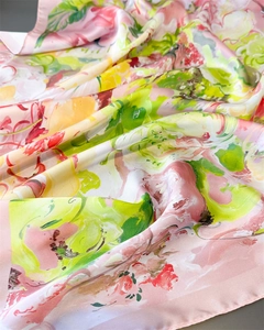 Detailed macro shot of abstract floral print silk scarf with smooth polished finish