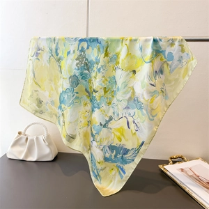 Close-up of abstract floral silk scarf draped elegantly showing glossy texture