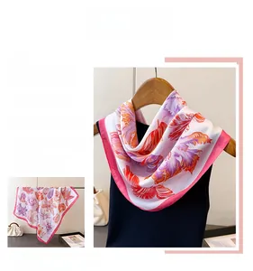 Detail of silk square scarf with pink feather print and contrasting bright pink borders