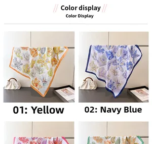 Detail view of floral silk scarves in yellow and navy blue with tulip print and satin sheen