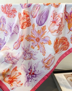 Macro detail of tulip print silk scarf with high-gloss finish and rolled edges
