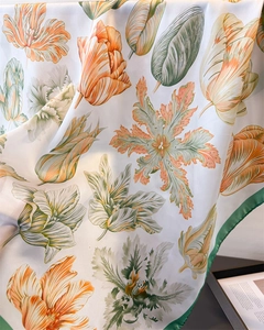 Detail of silk scarf with orange tulips print and green hand-rolled edges