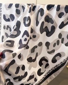 Detailed close-up of grey leopard print silk scarf showing lightweight fabric texture
