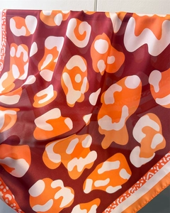 Detailed close-up showing the soft drape and texture of animal print faux silk scarf