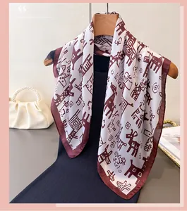 Detail of elegant white faux silk scarf with burgundy animal print and glossy texture