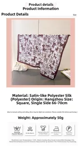 Detail view of printed silk satin square scarf featuring animal patterns and brown borders